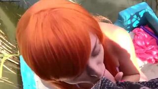 Redhead girl doing blowjob on a boat