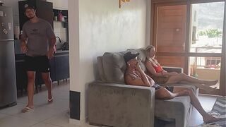 HER HUSBAND IN THE KITCHEN AND HER IN THE LIVING ROOM WITH HER FRIEND