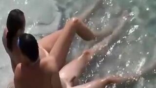 Nudist couple in the water